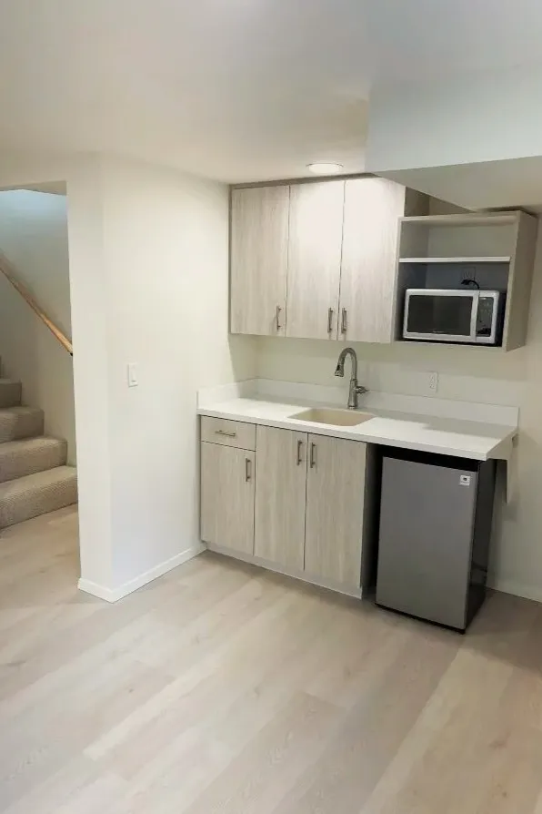 Finished basement with kitchenette, cabinets, and mini fridge in Mt. Tabor, southeast Portland home
