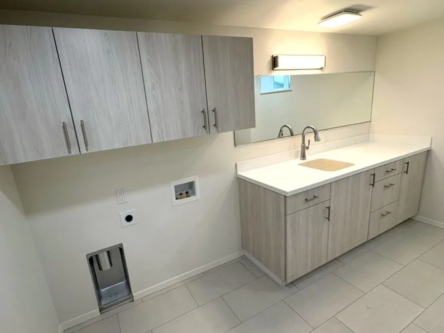 Basement remodel with bathroom vanity, storage cabinets, and laundry hookups in Mt. Tabor SE Portland home
