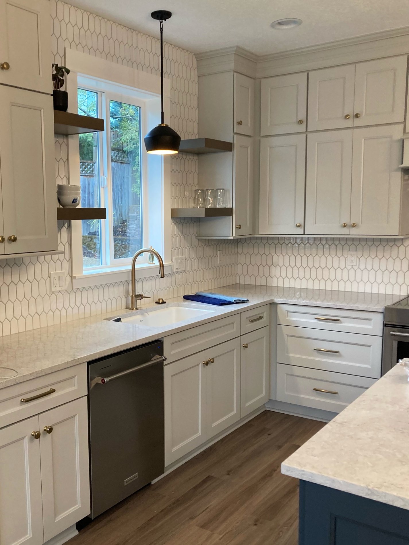 Damascus kitchen remodel detail showing white cabinetry, tile backsplash, and countertop finishes