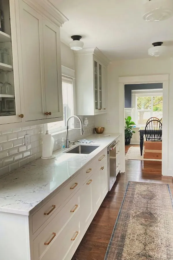 Kitchen remodel with white cabinetry, brass hardware, and subway tile in Brooklyn, Portland home